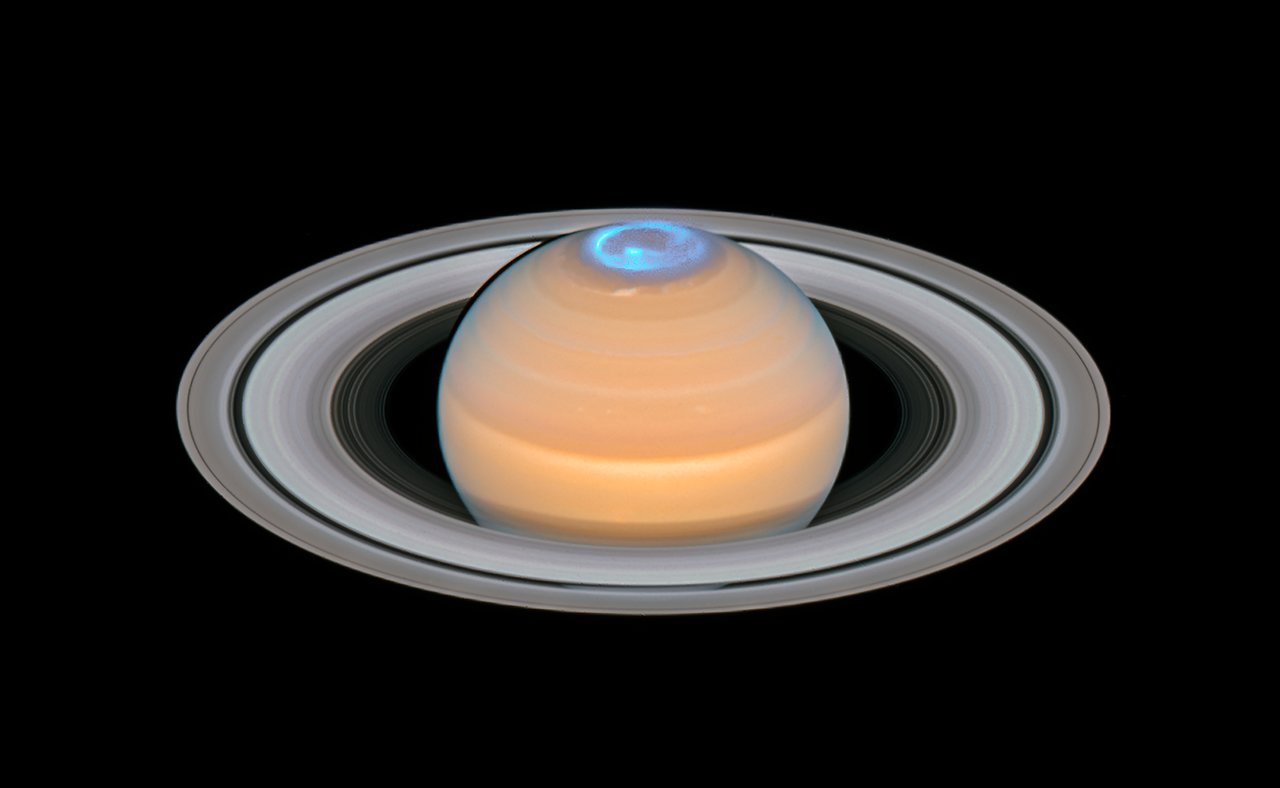 This image is a composite of observations made of Saturn in early 2018 in the optical and of the auroras on Saturn’s north pole region, made in 2017. In contrast to the auroras on Earth the auroras on Saturn are mainly visible in the ultraviolet — a part of the electromagnetic spectrum blocked by Earth’s atmosphere — and therefore astronomers have to rely on space telescopes like the NASA/ESA Hubble Space Telescope to study them.